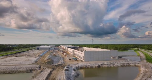 Construction Site of Logistic Center with Assembling of Concrete and Metal Frame Walls Aerial View