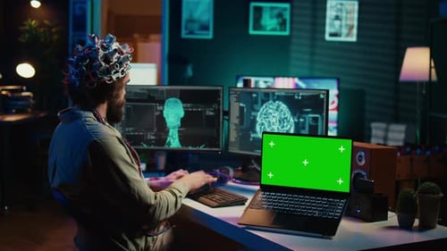 IT Admin Coding and Using EEG Headset to Upload Brain Into Green Screen Laptop