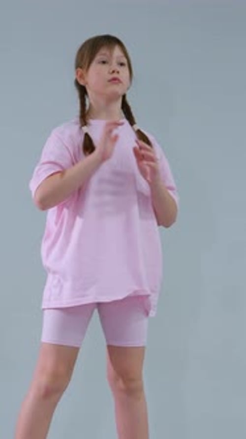 Young Child Practicing Balance on Rubber Squat Pads in Gym