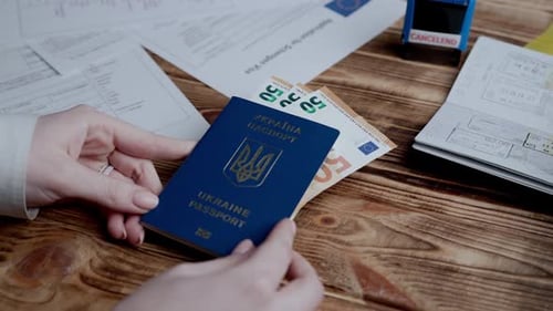 Close Up Shot of Person Identity Document Female Puts Ukrainian Passport with Money Tucked in on the