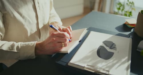 Businessman Taking Notes While Working In Office