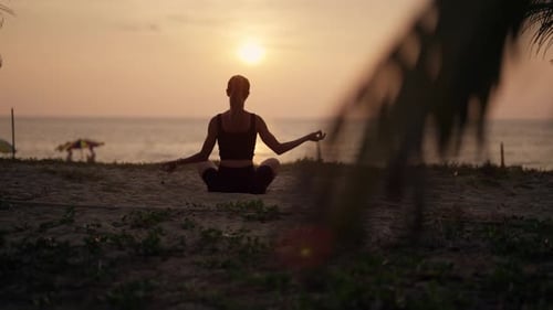 Une femme pratique le yoga sur l'océan au coucher du soleil Silhouette, yoga sportif, fille faisant une pose de yoga, exercice d'asanas
