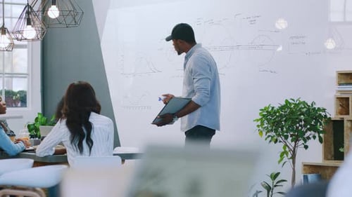 Man Giving Presentation to Colleagues in Bright Office