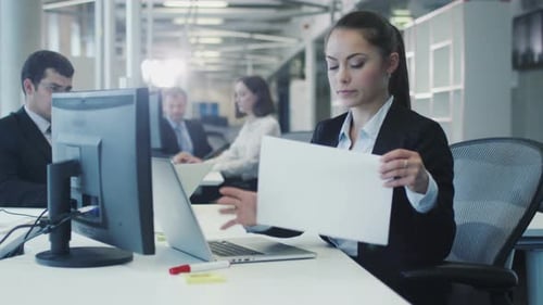 Stressed Female Worker Crumpling Documents