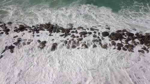 Massive Storm waves hitting and passing a wave breaker