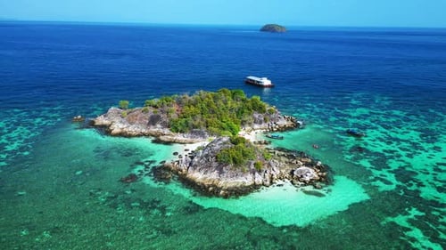 beach rocky cliff island turquoise blue sea. Best aerial top view flight wide orbit overview drone
4