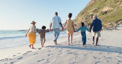 Beach, big family and holding hands while walking in nature for travel, love or freedom