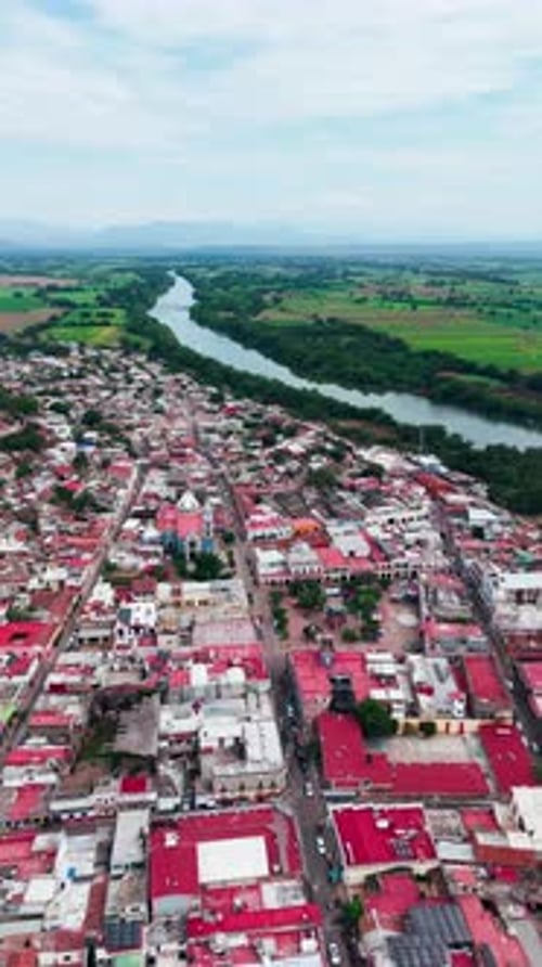 Drone flying over the town of Santiago Ixcuintla next to its river, Nayarit, Mexico