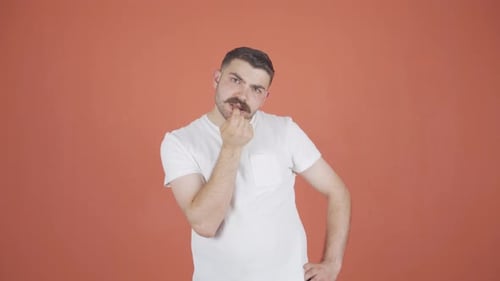 The man is biting his nails.