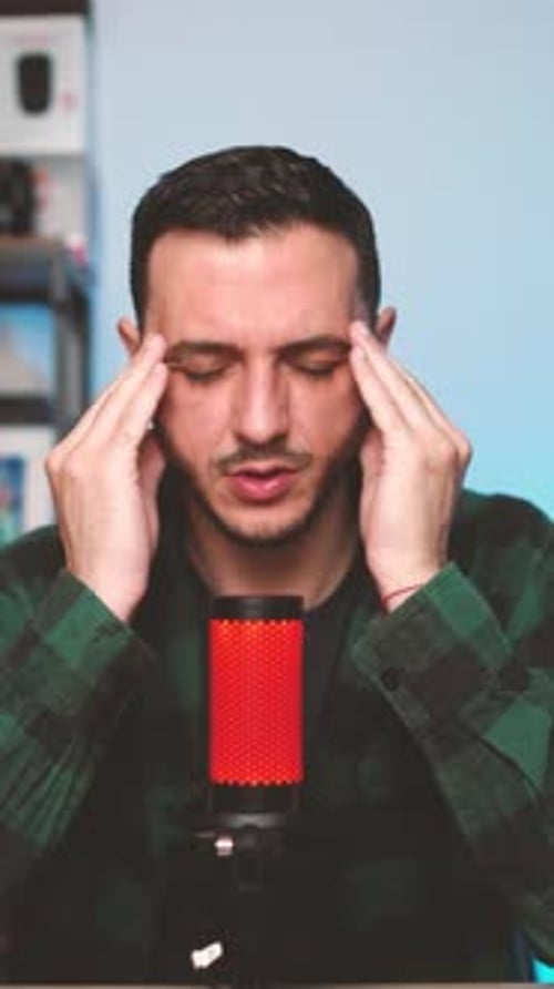 Modern Podcast Creator Recording Voice Content in Vertical Format with Studio Equipment and Focused