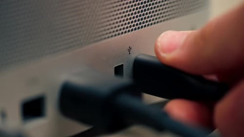 Closeup of USB Ports in a Computer with a Metal Case Many Different Connectors Inserted Type Wires