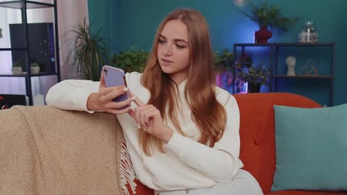 Woman Using Phone on Couch Indoors