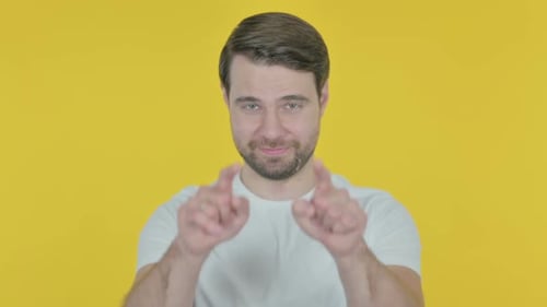 Young Man Inviting on Yellow Background
