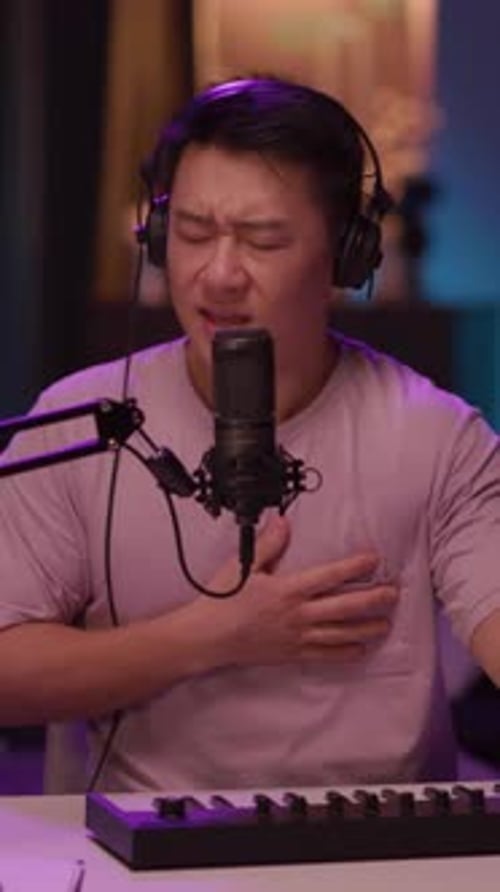 Musician Singing and Playing Keyboard in Home Studio