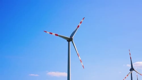 Wind Turbines Spinning Against a Blue Sky