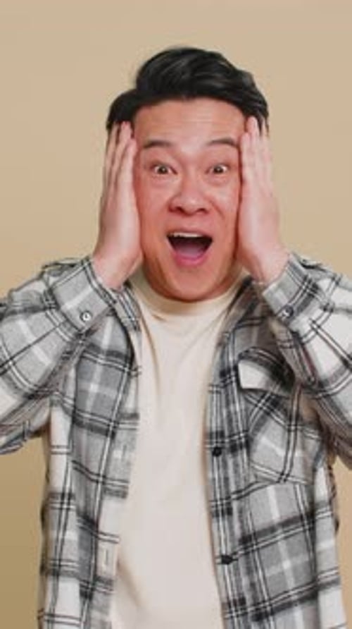 Man Expressing Surprise with Open Mouth and Hands
