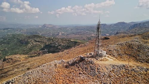 Communication tower on a mountain peak overlooking a vast landscape
