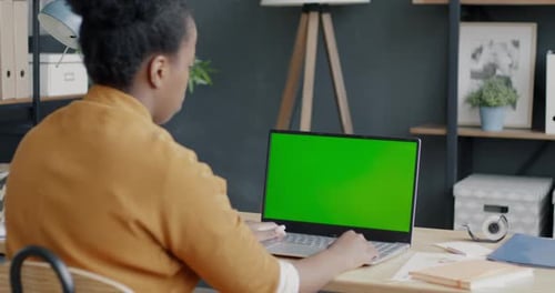 African American Businesswoman Working with Chroma Key Green Screen Typing Indoors in Office
