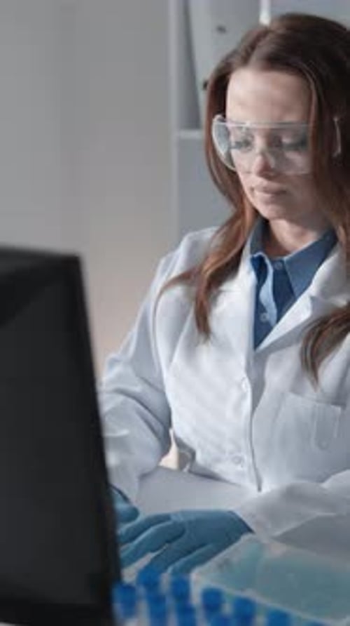 Woman Working in Science Lab on Computer