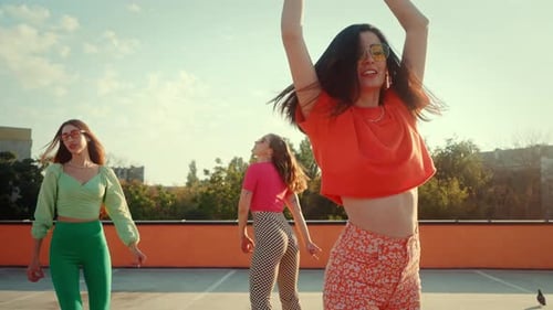 Sporty Females in Hippie Clothes Dancing on Roller Skates