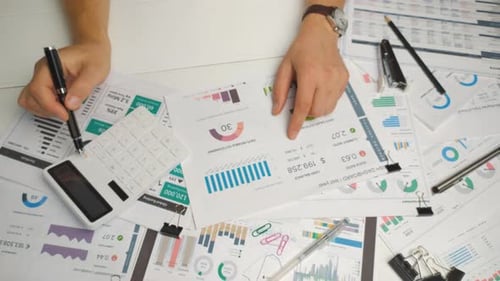 Top View of the Accountant's Hands Checking the Financial Report