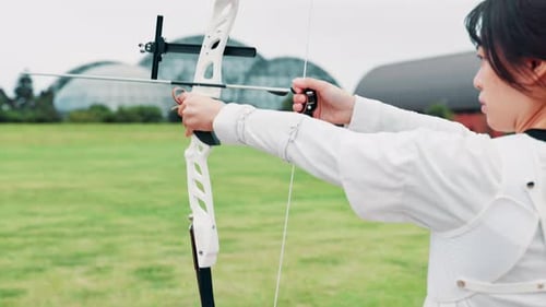 Archery, bow draw and training with woman in Japan for shooting game, challenge and target practice