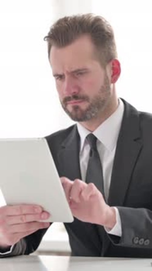 Young Businessman Reacting to Loss on Tablet in Office, Vertical Video