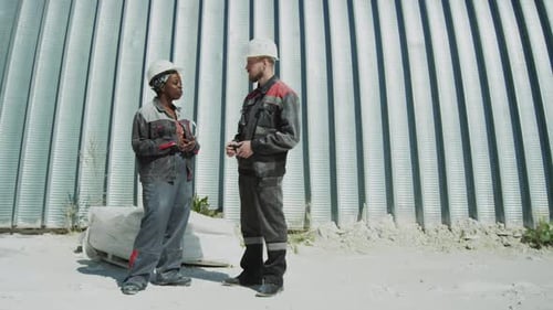 Diverse Couple of Plant Workers Talking Outdoors