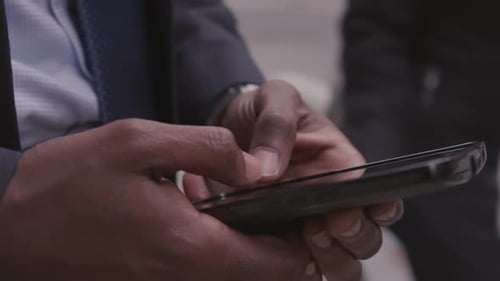 A man is typing on his phone
