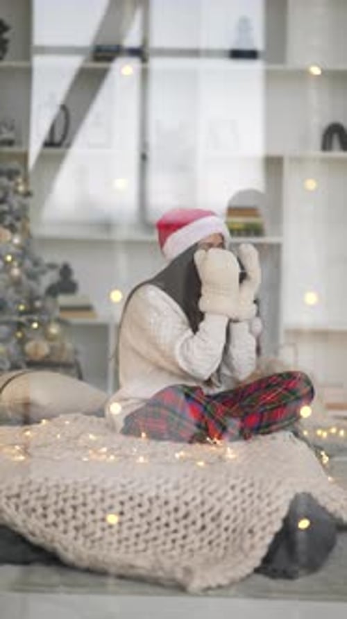 Woman Enjoying Christmas Coffee in Cozy Home