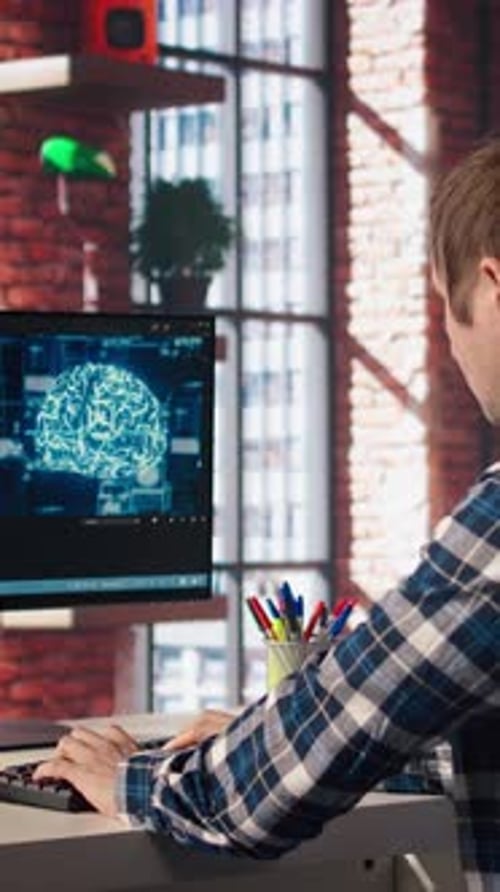 Man Working on Computer with Brain Animation