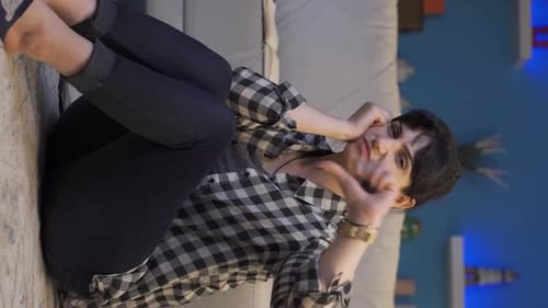 Distressed Woman Sitting on Living Room Floor