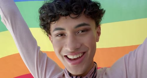 Person Smiling With Pride Flag Close Up