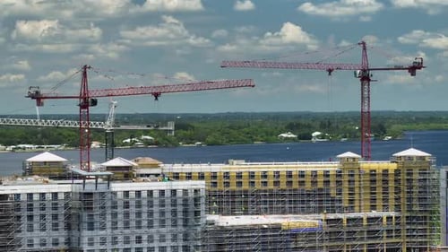 Tower Cranes and Frame Structure of High Residential Apartment Buildings at Construction Site