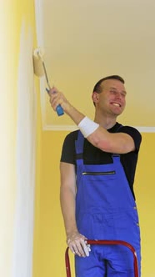 Smiling Man Painting Wall White