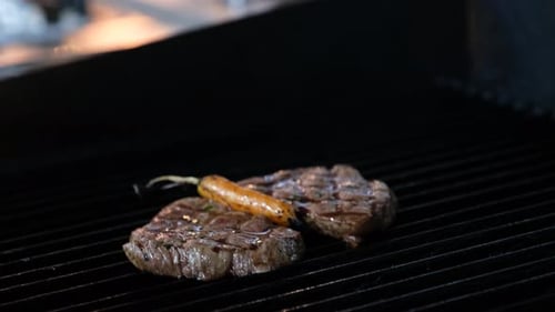 Sizzling Steak with Carrot on Restaurant Grill