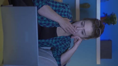 Tired Woman Working on Laptop at Night