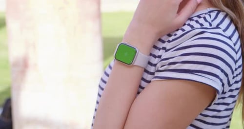 Woman Wearing Apple Watch with Chroma Key Screen
