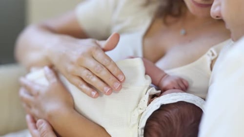 Parents Comforting Newborn Baby at Home