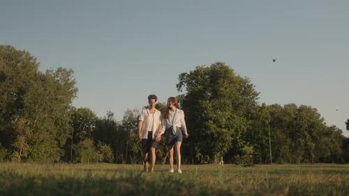 Couple Holding Hands In The Park