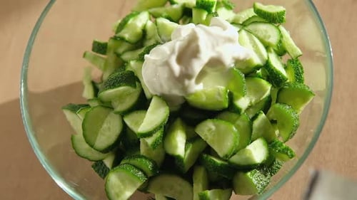 Cucumber Salad Delicious Green Salad with Cucumbers Onion Dill and Greek Yogurt Preparation in a