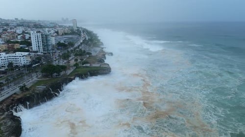 Aerial view of tumultuous ocean with frothing waves due to Hurricane Beryl passing by