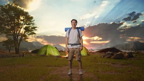 Asian Male Smiling To Camera While Tent Camp Lakeside