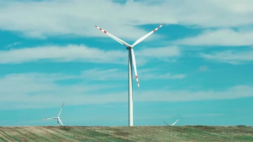 Closeup view on wind turbine of wind farm on blue sky background, Poland