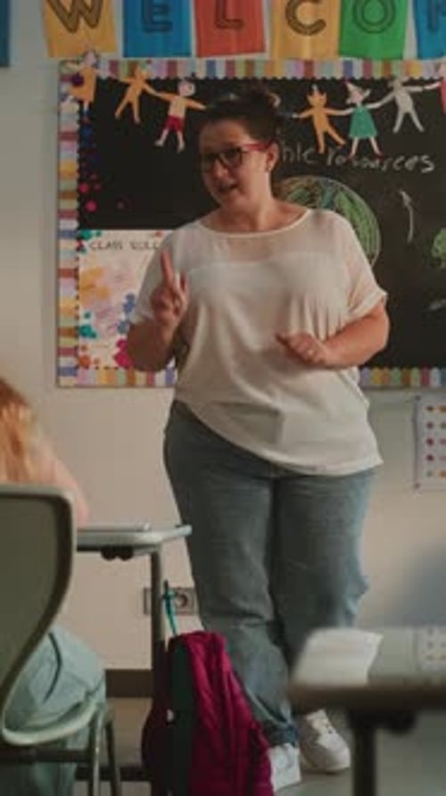 Teacher Giving Lesson in Classroom at School