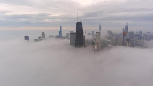 A chicago skyline consist of misty clouds. Foggy, white, beautiful, view of John Hancock tower and t