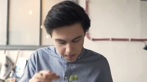 Young Teenager Eating Sandwich in Cafe Adolescent
