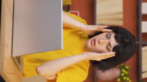 Woman with Headache at Laptop in Home Office