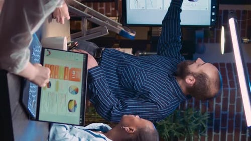 Workers Discussing Data in an Urban Office