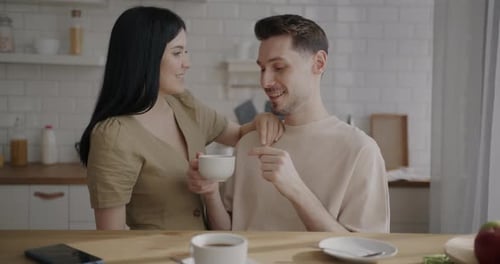 Couple Talking Together in a Bright Kitchen